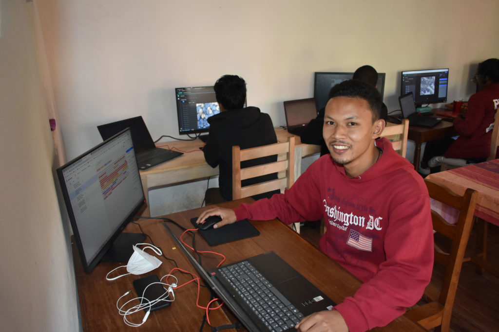 man working in front of a computer, our impact social